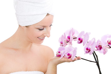 Caucasian woman with towel on head and violet orchide