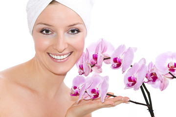 Caucasian woman with towel on head and violet orchide - obrazy, fototapety, plakaty