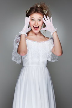 portrait of amazed woman in white dress