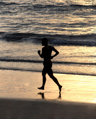 Man running on beach - 21400322