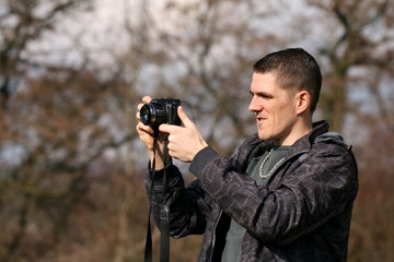 man takes photograph