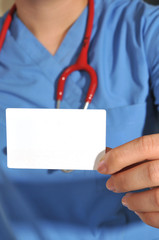 A medical nurse holding a business card