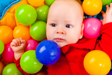 Fototapeta na wymiar Infant with colorful balls