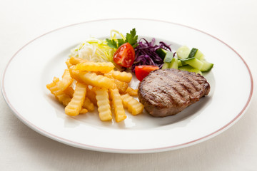 Grilled steak with chips and vegetables