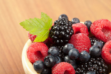 fresh berries in wood bowl