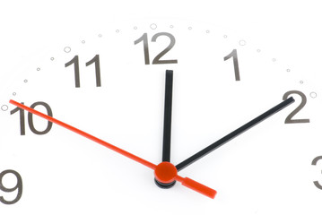 White clock showing time about twelve isolated