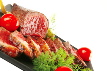 sliced meat on dark plate