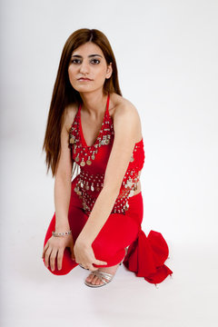 Pretty belly dancer resting on the floor