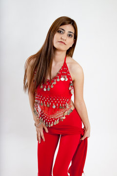 Pretty belly dancer dancing with a red scarf