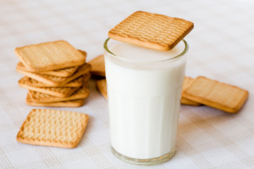 glass of fresh milk and cookies on the table