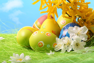 Easter Eggs sitting on grass field with blue sky