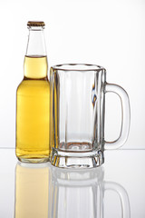 A bottle of beer and an empty mug