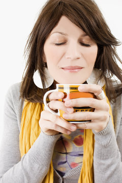 Attractive lady drinking hot beverage.