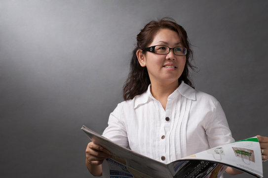 Asian Woman Reading Newspaper