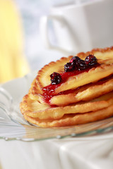 Pile of pancakes with fruit sauce