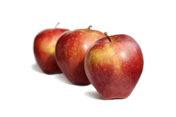 Three red apples on white background