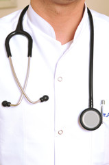 A vertical image of a doctor with stethoscope holding