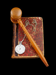 Judge's gavel and very old legal book with watch isolated