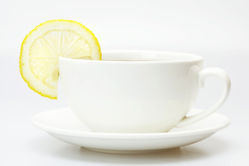 white cup and lemon isolated on white