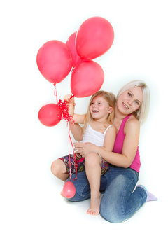 happy mother and daughter with red balloons over white