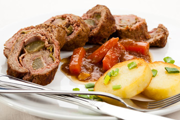 Roasted, stuffed pork chop with chips and vegetables