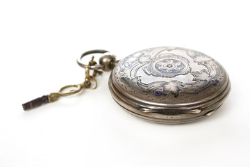 old pocket silver swiss closed watch with key on white