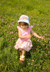 The girl runs on a grass