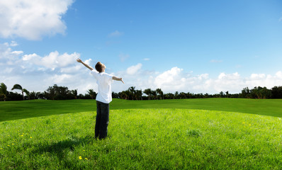 young man relax on the green field