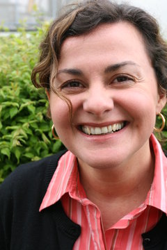 Woman, forty years old, brown curled hair, laughing