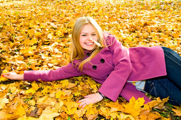 portrait of young smiling woman on the leaves