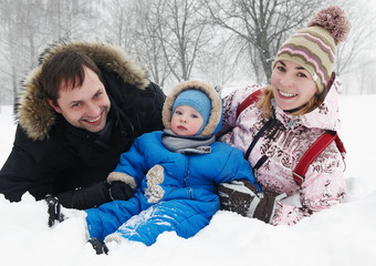 Fototapeta premium smiling family with child in winter