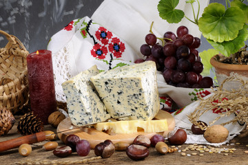 composition with cheese, fruits and objects