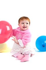 Fototapeta na wymiar baby playing with colorful balloons