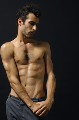 Naklejka premium Sport and health body of young man. On black