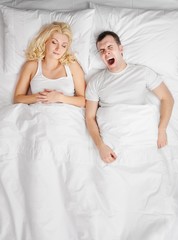 Obraz na płótnie Canvas Young couple sleeping in a bed