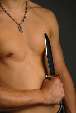man holding knife on a torso