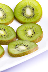 Fototapeta premium Kiwi slices on white plate
