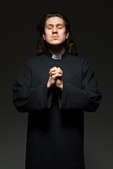 young priest is praying