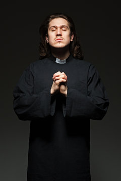 Young Priest Is Praying