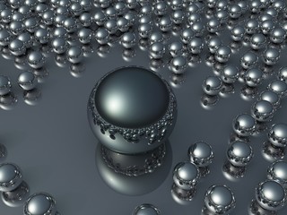 Single oversized chrome ball among many the same
