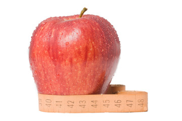 apple with a ruler on a white background