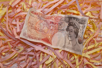 fifty pound note on shredded paper