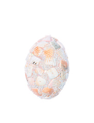 Decorative egg made from shells on white