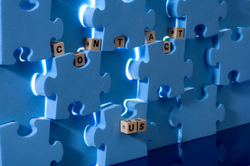 Blue puzzle with  wood letter