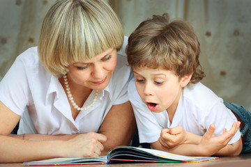 woman and little boy reading book