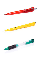 three pens at white