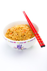Bowl of cooked rice with chopsticks over white background