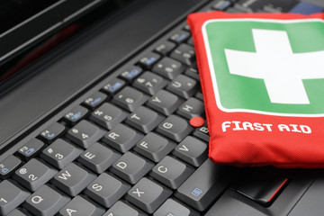 First aid kit on laptop keyboard - 21539395