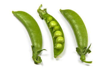 Fresh green peas on white