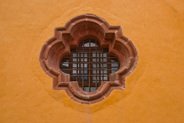 Window on yellow wall